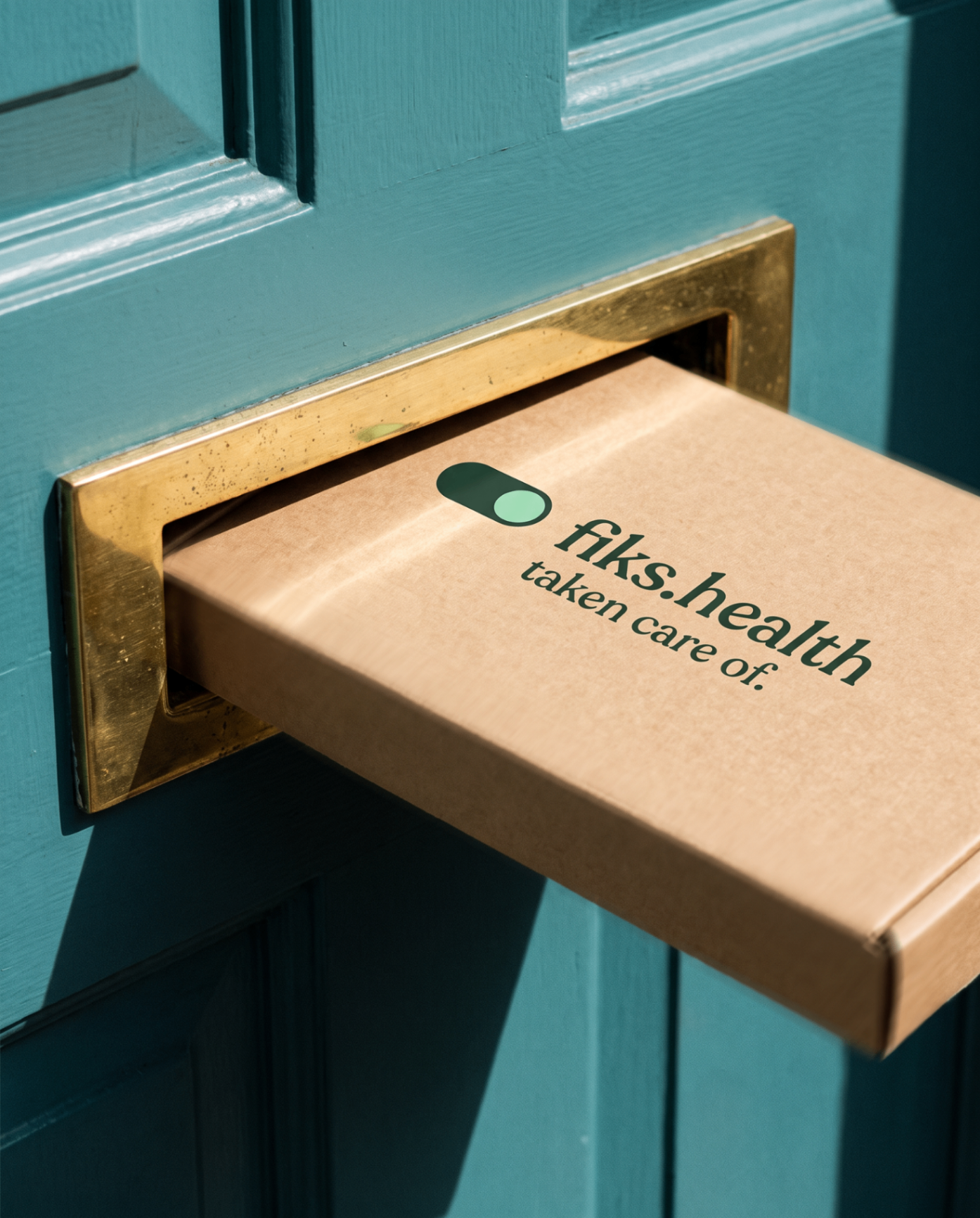 A kraft brown fiks.health mailer box passing through a brass letterbox in a closed teal front door, printed with the fiks.health wordmark and 'taken care of.'