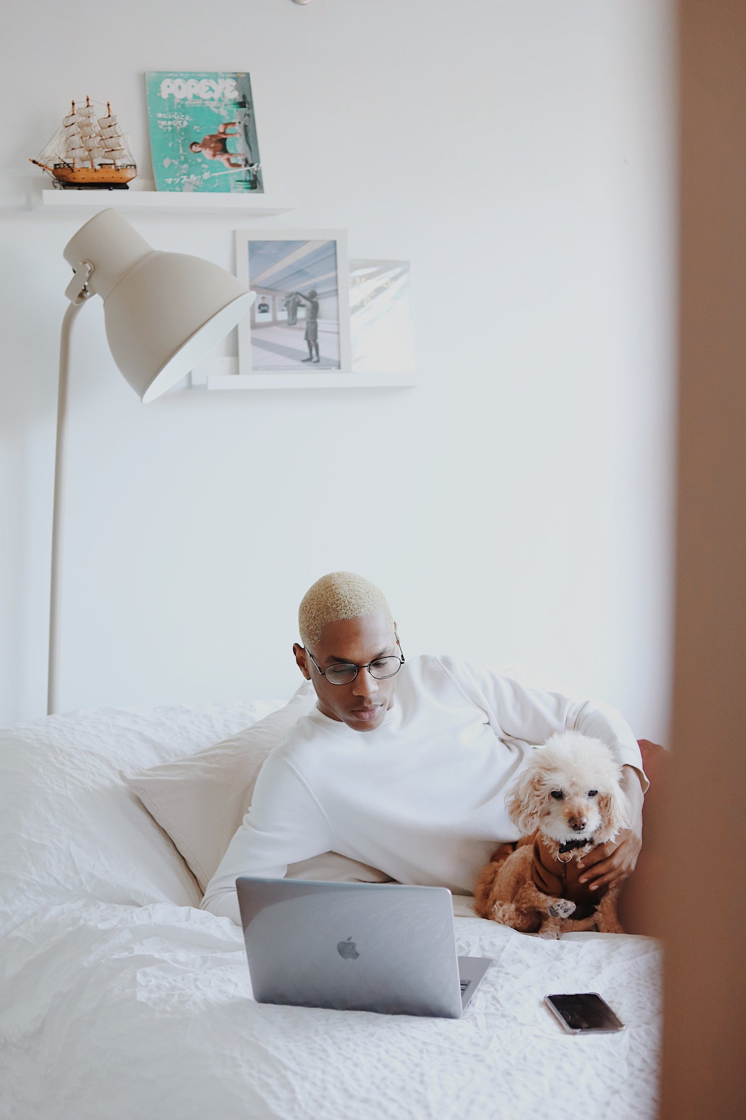 A Man Relaxing Focusing on Computer with a Dog