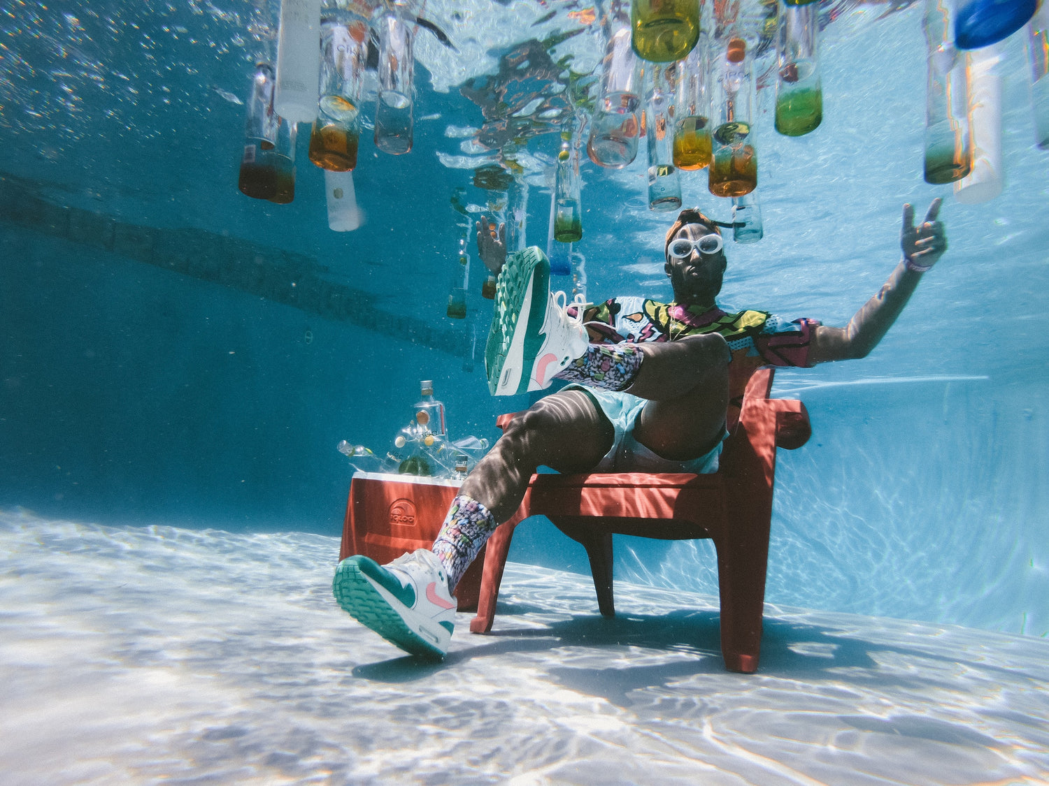 A Man Relaxing Underwater in a Chair
